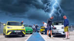 Auto Express team standing with a selection of EVs underneath a lightning storm